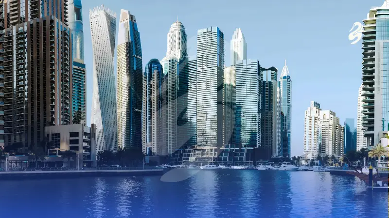 Scenic waterfront view of a modern luxury city skyline featuring towering skyscrapers, a twisting architectural tower, and moored boats along a calm blue harbor channel.